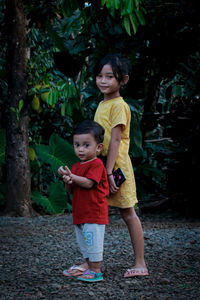 Full length portrait of happy friends standing outdoors