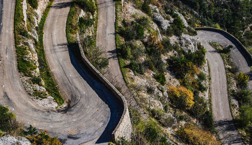 High angle view of winding road amidst trees