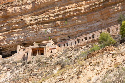 Scenic view of old stone houses, palm trees ghoufi canyon in the aures region, algeria