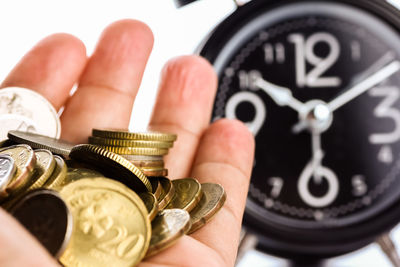 Close-up of hand holding coins