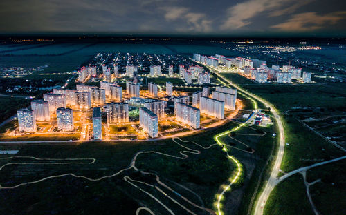 High angle view of city buildings against cloudy sky