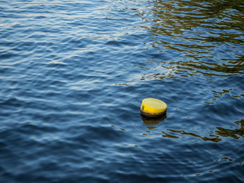 High angle view of yellow buoy floating on water