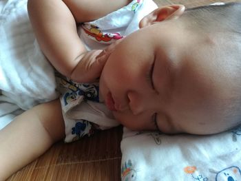 High angle view of baby sleeping on bed at home