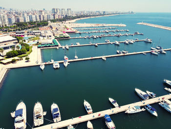 Yachts and boats moored at marina and panorama of seaside city.