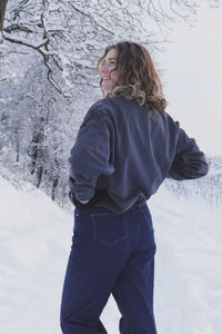 Woman standing on snow covered land