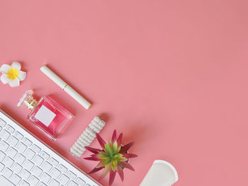 Directly above shot of beauty products on pink background
