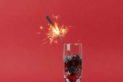 Firework display against red background