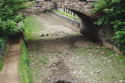 Walkway amidst stone wall