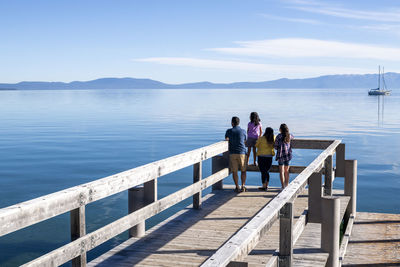 A family relaxes on a pier on a beautiful day in south lake tahoe, ca