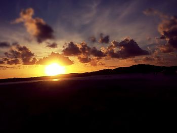 Scenic view of beach against sky during sunset