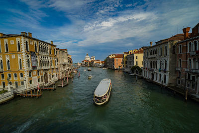 View of canal amidst buildings in city