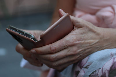 Midsection of man using mobile phone