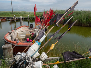 Fishing net on lake against sky