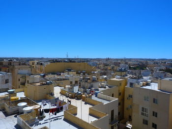 High angle view of townscape against clear blue sky