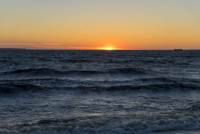 Scenic view of sea against romantic sky at sunset