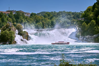 Scenic view of waterfall against sky