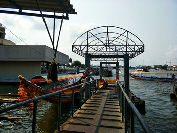 Pier over river against sky