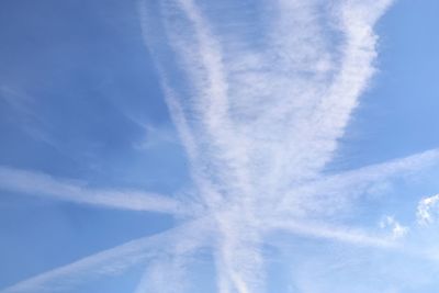 Low angle view of vapor trail against blue sky