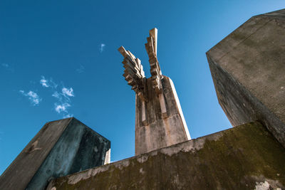 Low angle view of old wooden post against sky