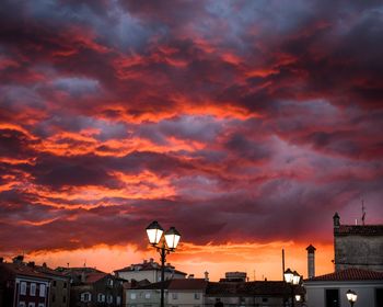 Silhouette of cityscape against dramatic sky