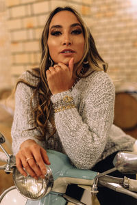 Portrait of young woman sitting outdoors