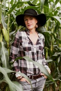 Portrait of woman standing against plants