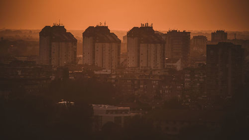 Buildings in city during sunset