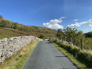 Road to halton gill, with dry stone walls, wild grasses, and trees in,  littondale, skipton, uk