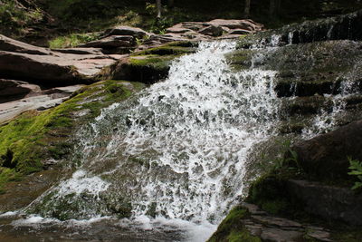 Scenic view of river flowing through rocks