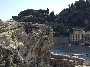 View of cliff by sea against clear sky