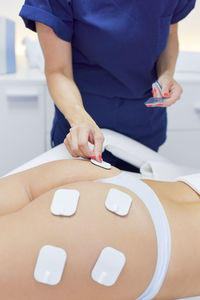 Midsection of woman holding ice cream on table