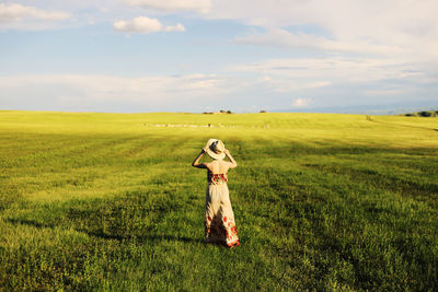 Full length of man standing on field against sky