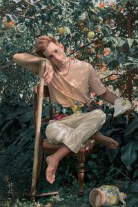 Full length of young woman sitting outdoors