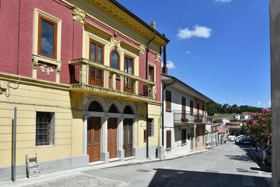 A narrow street among the old houses of greci, a village in the campania region, italy.