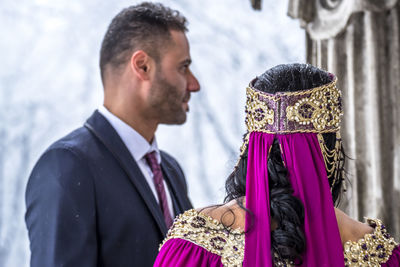 Rear view of bride with bridegroom during weeding ceremony