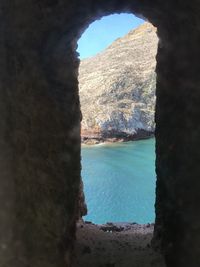 Scenic view of sea and rock formation against sky