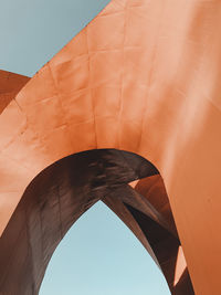 Low angle view of bridge and building against sky