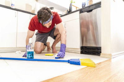 Full length of man working on wooden floor