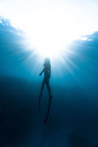 Low angle view of woman swimming in sea