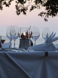 View of wine glass on table against sunset