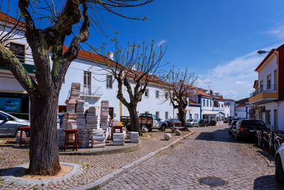 Street amidst houses and buildings against sky