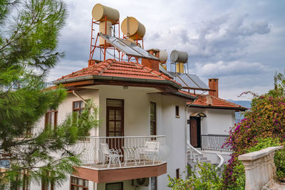 Concept saving electricity. roof of houses with solar panels and water barrels. solar energy.