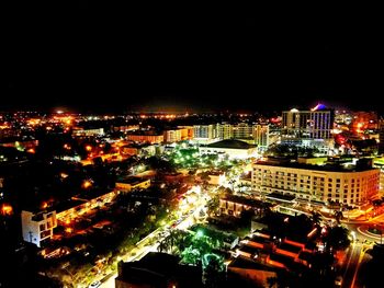 Aerial view of city lit up at night