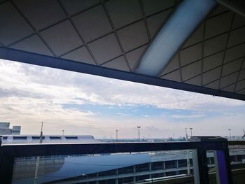 Low angle view of railroad station against sky