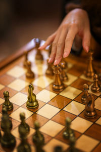 Cropped hand playing chess