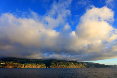 Scenic view of mountains against blue sky