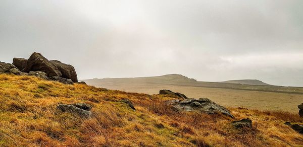 Rock formations on landscape against sky