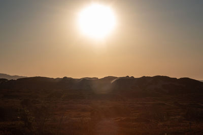 Scenic view of mountains against sky during sunset