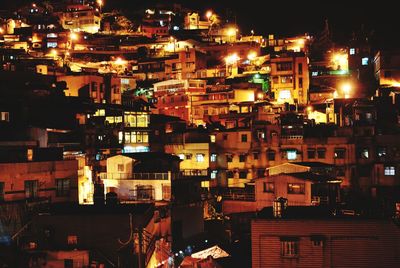 Illuminated cityscape against sky at night