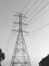 Low angle view of electricity pylon against sky